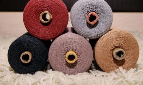 Large five spools of thread lie on top of each other on a white background Stock Photos