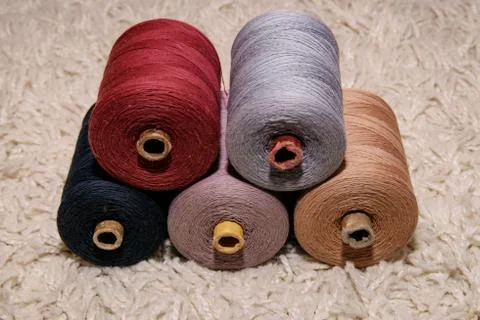Large five spools of thread lie on top of each other on a white background Stock Photos
