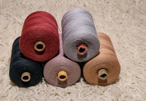 Large five spools of thread lie on top of each other on a white background Stock Photos