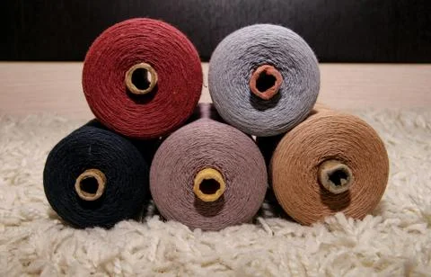 Large five spools of thread lie on top of each other on a white background Stock Photos
