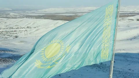 Large flag of Kazakhstan fluttering in wind against the background of mountains  Stock Footage 233363846