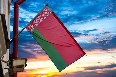A large flag of the Republic of Belarus on the background of the evening sk.. Stock Photos