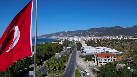 A large flag of Turkey flutters on a flagpole. Aerial 4k shooting from a drone Video stock 224636883
