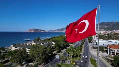 A large flag of Turkey flutters on a flagpole. Aerial 4k shooting from a drone Video stock 224637012