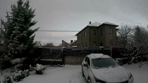 Large flakes of snow fall in the courtyard of a European house Stock Footage 167348484