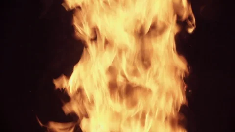 A large flame burns and ashes slowly fly out of it Stock Footage 127862872