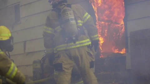 Large flames billow from a house Video stock 60761565