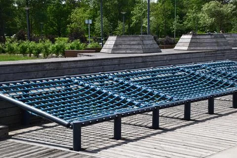 Large flat blue rope net climbing structure with dark metal frame mounted Stock Photos