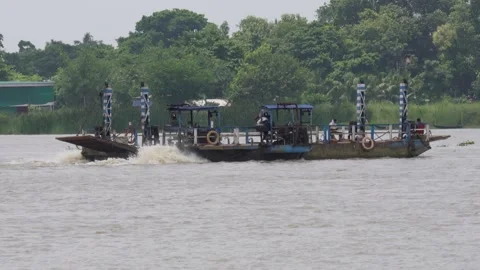A large, flat-bottomed boat on a river Stock Footage 314513385