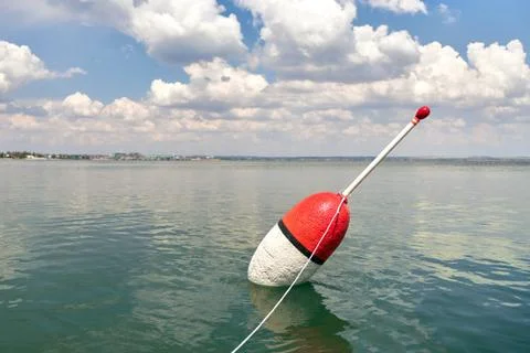 Large float on a calm surface of the sea as a symbol of successful fishing Stock Photos