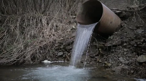 With a large flow pipe waste directly into the river Stock Footage 61289363