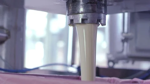 A large flow of sour cream is going out of the crane at the plant Stock Footage 92372200