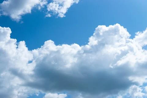 Large fluffy clouds in the blue sky. Stock Photos