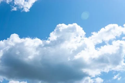 Large fluffy clouds in the blue sky. Stock Photos