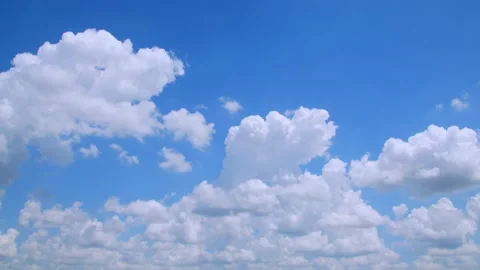 Large fluffy clouds floating in a blue sky on a spring day. 4k60p Video stock 132219665