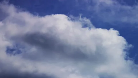 Large fluffy white clouds move smoothly across blue sky Stock Footage 329758418