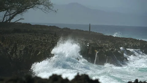 Large foamy sea waves break on the rocky seashore and foamy splashes fly upwards Stock Footage 231517113