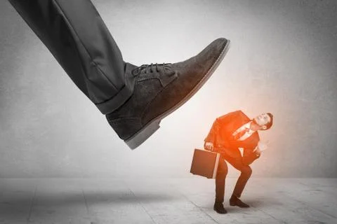 Large foot stepping down small man Stock Photos