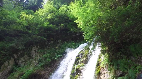 Large forest waterfall on a moss covered slope in summer Stock Footage 68414238
