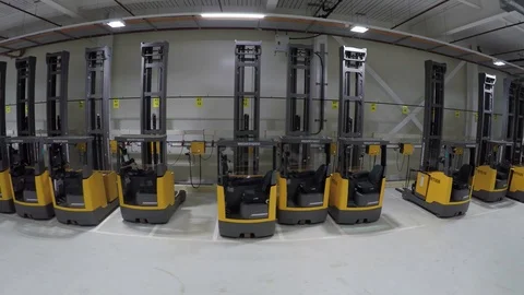 Large forklift trucks being charged at charging stations, drone aerial 4K Stock Footage 101115658