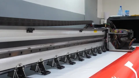 Large format inkjet printing press in operation. Working large format printer Stock Footage 99525407