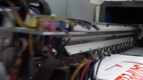 Large format inkjet printing press in operation. Working large format printer Stock Footage 99525460