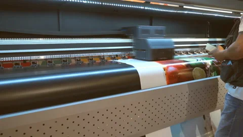 A large format Printer inkjet device machine running motion vinyl white sheet co Stock Footage 135223050