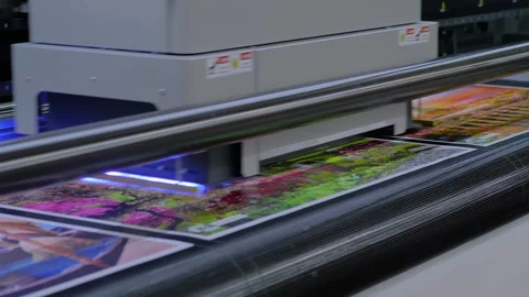 Large format printer is printing colorful promotional material Vídeos de archivo 344332343
