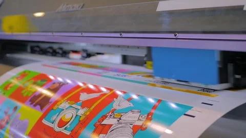 Large format printer prints colorful promotional material with illustrations Stock Footage 329943825