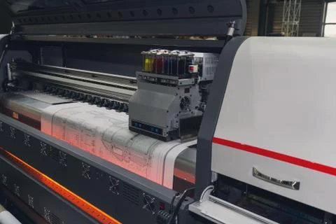 Large format printing machine in operation. Industry Stock Photos