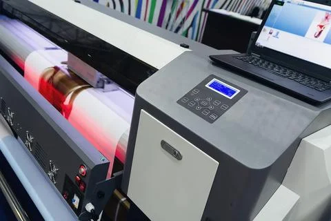 Large format printing machine in operation. Industry Stock Photos