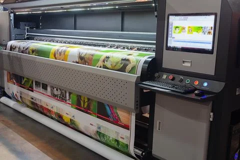 Large format printing machine in operation. Industry Stock Photos