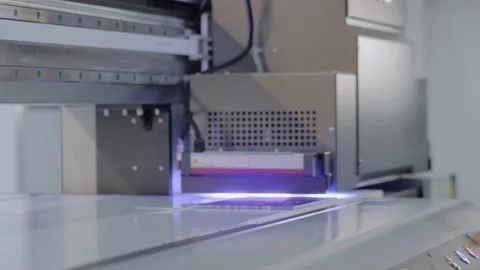 Large format printing - UV digital flatbed printer during work at printing house Stock Footage 143932357