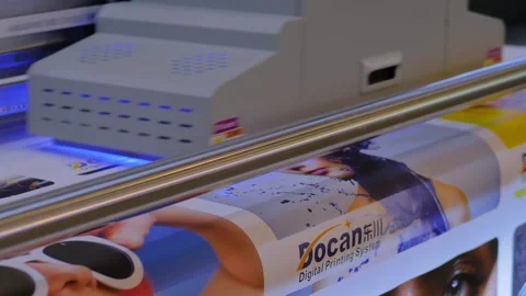 Large format UV digital flatbed printer prints colorful promotional material 動画素材 347246383