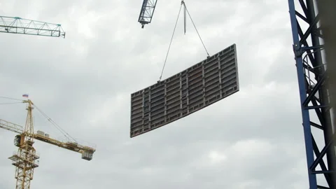 Large formwork panel suspended by crane at construction site Stock Footage 326824519