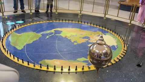 Large Foucault Pendulum Swinging Over World Map Exhibit in Science Museum Stock Footage 338118517