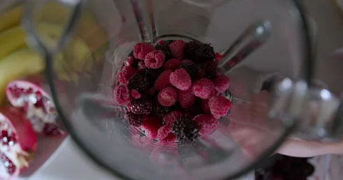 Large frame of fresh berries that slowly fall into the blender to later become 스톡 동영상 147390004