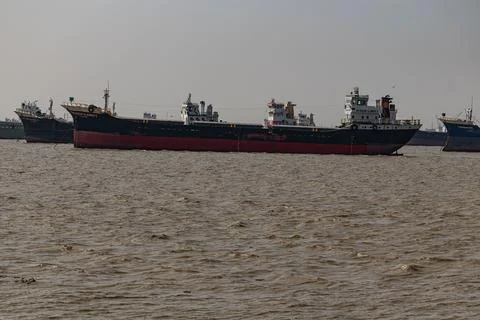 Large freight ship floating in the ocean near Patenga Stock Photos