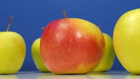 Large fresh apples rotates on blue backdrop Stock Footage 324682083