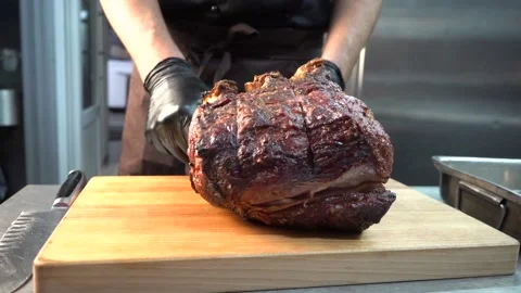 A large fried piece of meat the grilled chef puts on a cutting board Stock Footage 144873373