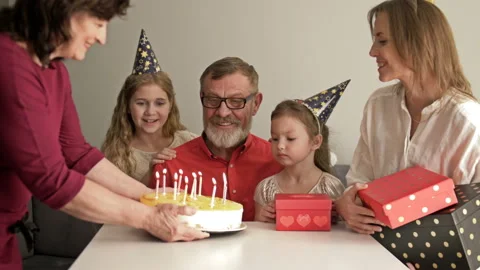 Large friendly multi-generation family standing together in home and watching Video stock 128317341