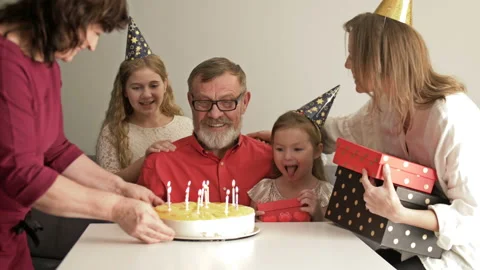 Large friendly multi-generation family standing together in home and watching Stock Footage 128318445