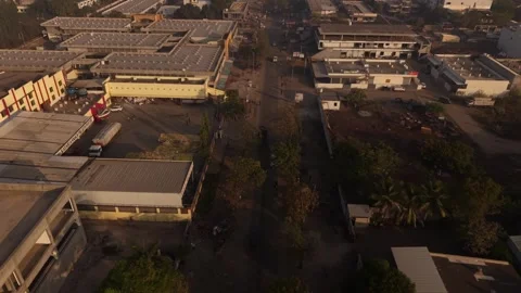 A large fronted warehouse facility where a long flatbed trailer truck is Stock Footage 334125290