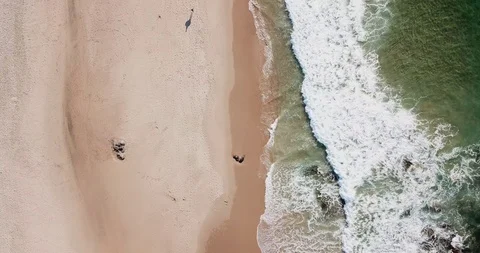 Large frothy waves on the sandy empty ocean coast from a bird's-eye view Stock Footage 130168417