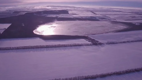 Large frozen lake in the middle of the forest, aerial photography Stock Footage 83572062