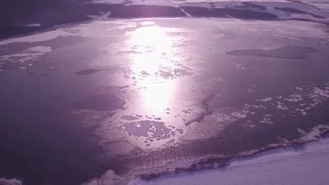 Large frozen lake in the middle of the forest, sunset, cold winter, 4K Stock Footage 83575803