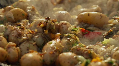 A large frying pan is being used to cook potatoes. Stock-Footage 313299872