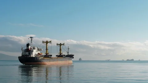 A large fuel ship, reflected in the sea water, leaves the port Video stock 102681316