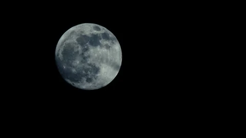 A large full moon moves slowly across the night sky Stock Footage 274316014