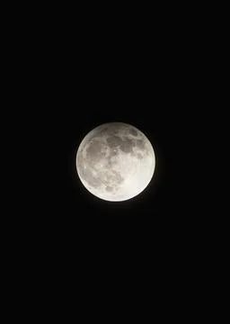 A large, full moon is in the sky Stock Photos